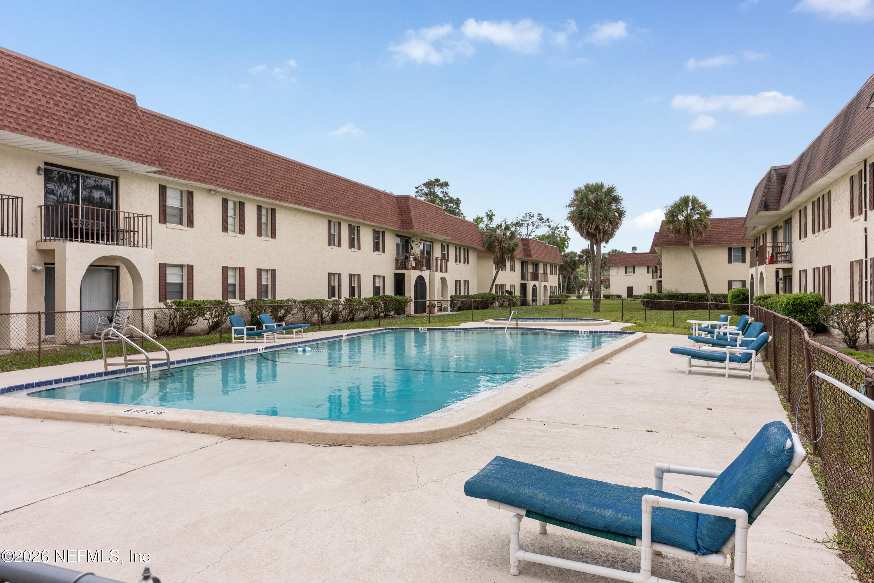 1716 El Camino Road, Unit 6 Jacksonville, FL 32216 - Photo 18 of 18 a view of swimming pool with outdoor seating and house in the background