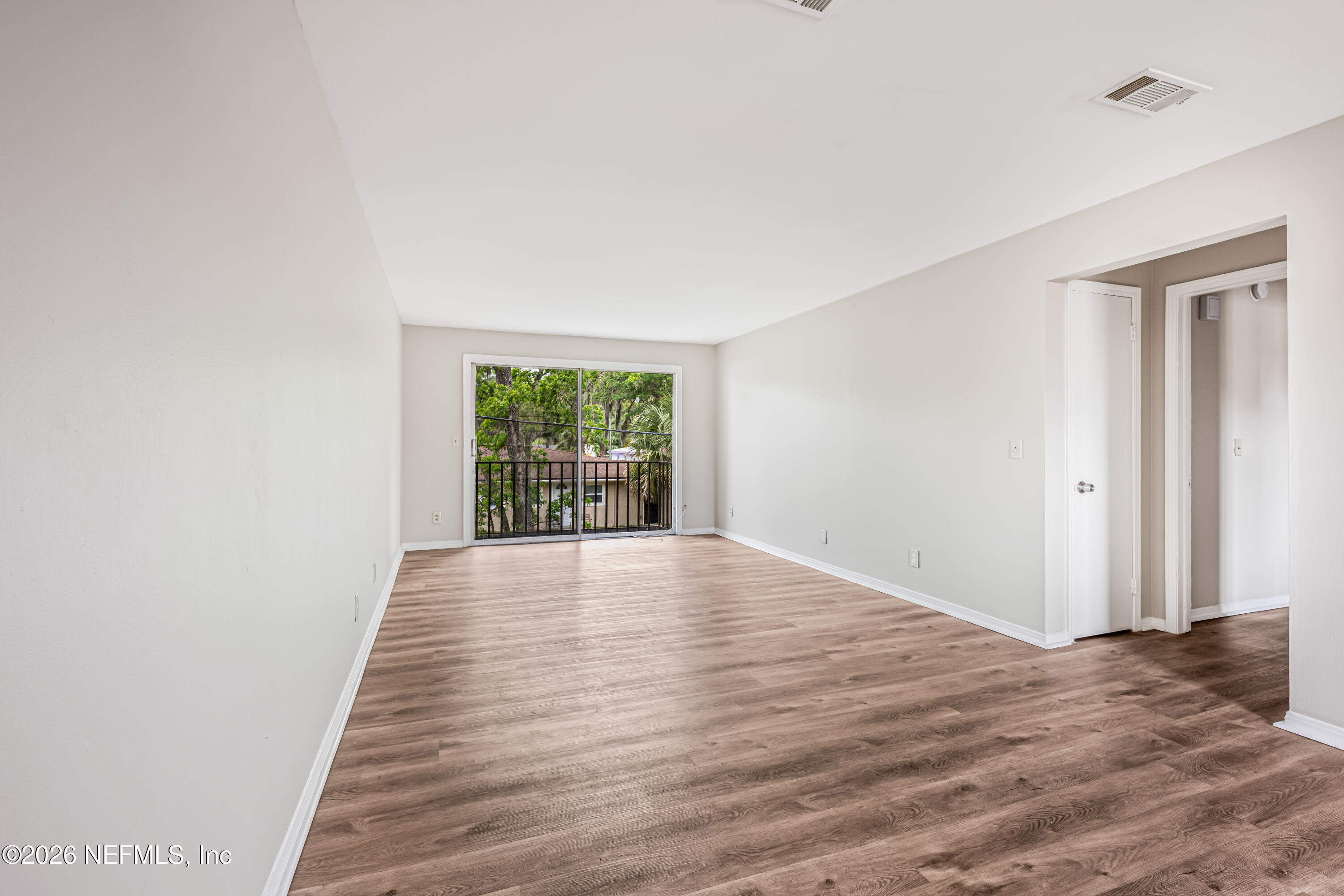 1716 El Camino Road, Unit 6 Jacksonville, FL 32216 - Photo 2 of 18 an empty room with wooden floor and windows
