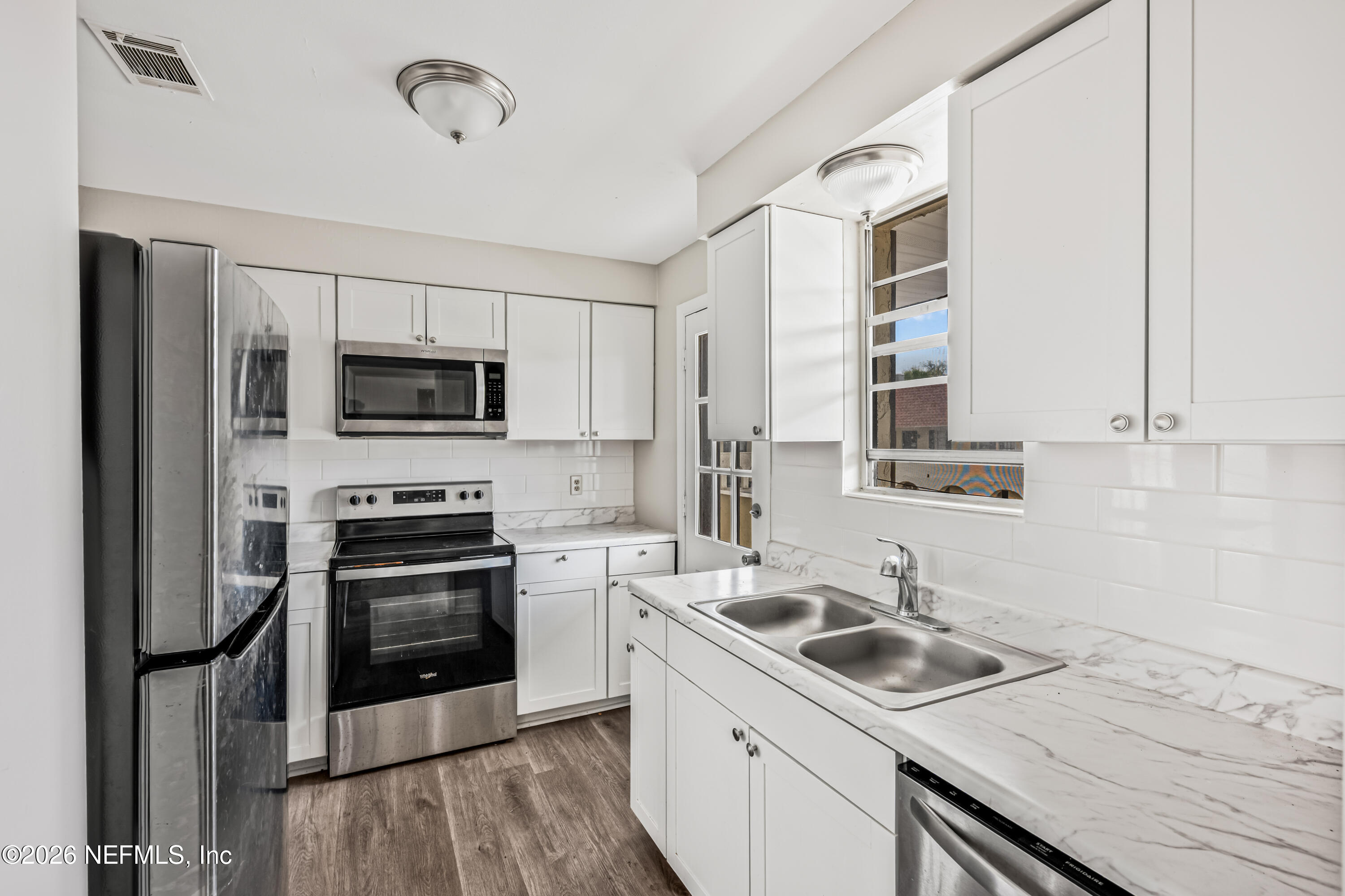 1716 El Camino Road, Unit 6 Jacksonville, FL 32216 - Photo 7 of 18 a kitchen with a sink appliances and cabinets