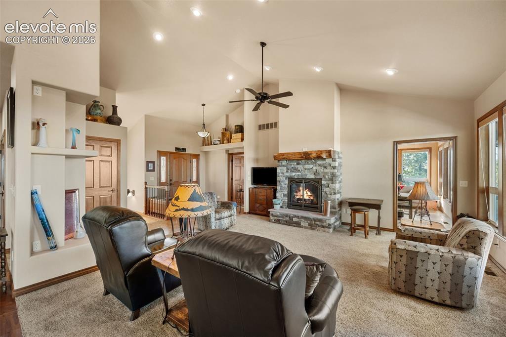 131 Paradiso Road Divide, CO 80814 - Photo 15 of 50 a living room with furniture a fireplace and a chandelier