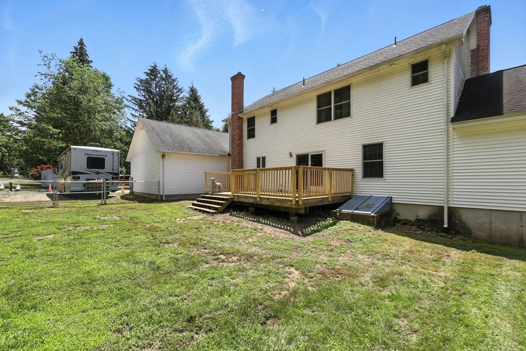 285 Lower Hampden Road Monson, MA 01057 - Photo 6 of 40 a backyard of a house with barbeque oven and seating space