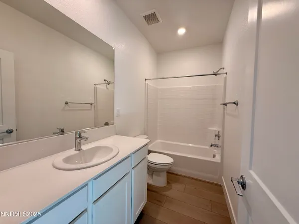 a bathroom with a sink toilet a shower and a mirror