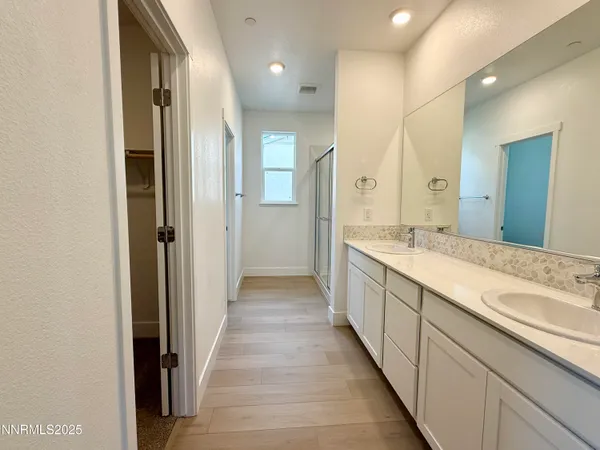 a large bathroom with a double vanity sink and a mirror