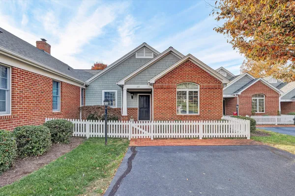 a front view of a house with a garden and deck