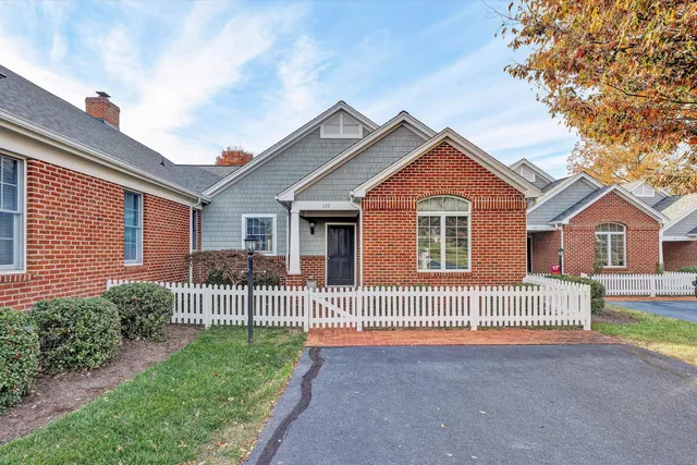 a front view of a house with a garden and deck