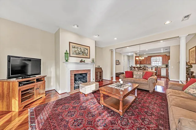 a living room with fireplace furniture and a flat screen tv