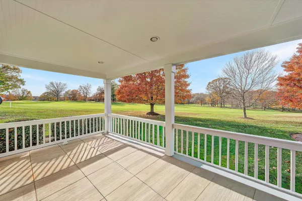 a view of a deck with wooden floor and fence