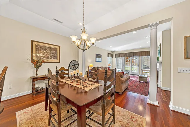 a view of a dining room with furniture wooden floor and chandelier