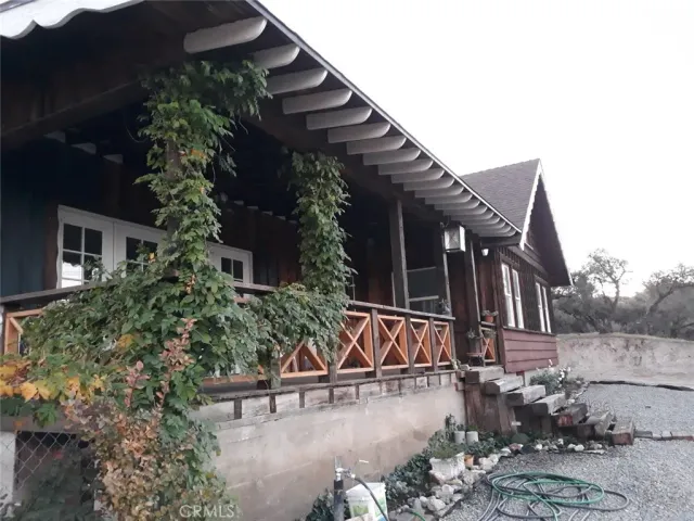 a view of a house with a yard and sitting area