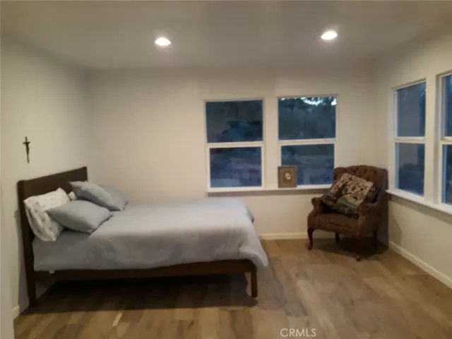 a bedroom with a bed and glass window