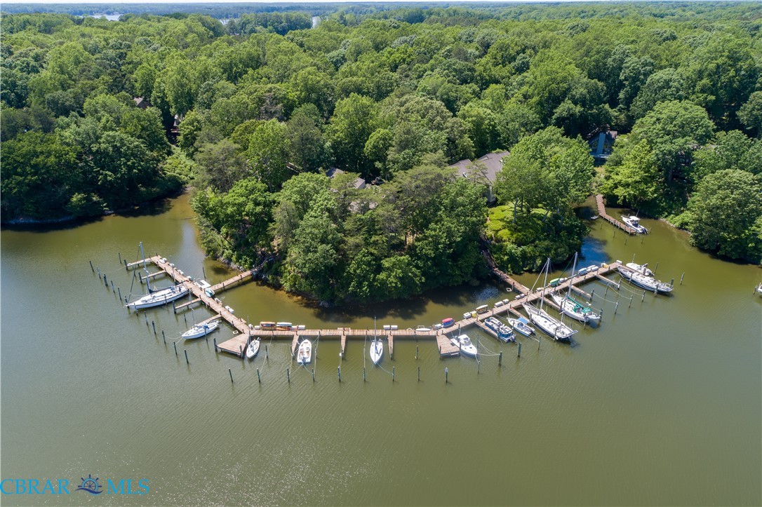 54 Villa Ridge Drive, Unit C Hartfield, VA 23071 - Photo 10 of 45 Aerial view of a large body of water and a heavily wooded area