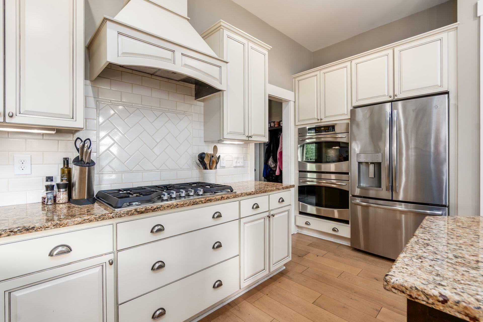 1002 Rambling Brook Way Delaware, OH 43015 - Photo 26 of 104 Spacious kitchen with center island, stainless steel appliances including gas range and double oven, built in microwave, beverage refrigerator, walk-in pantry and sunny breakfast room.