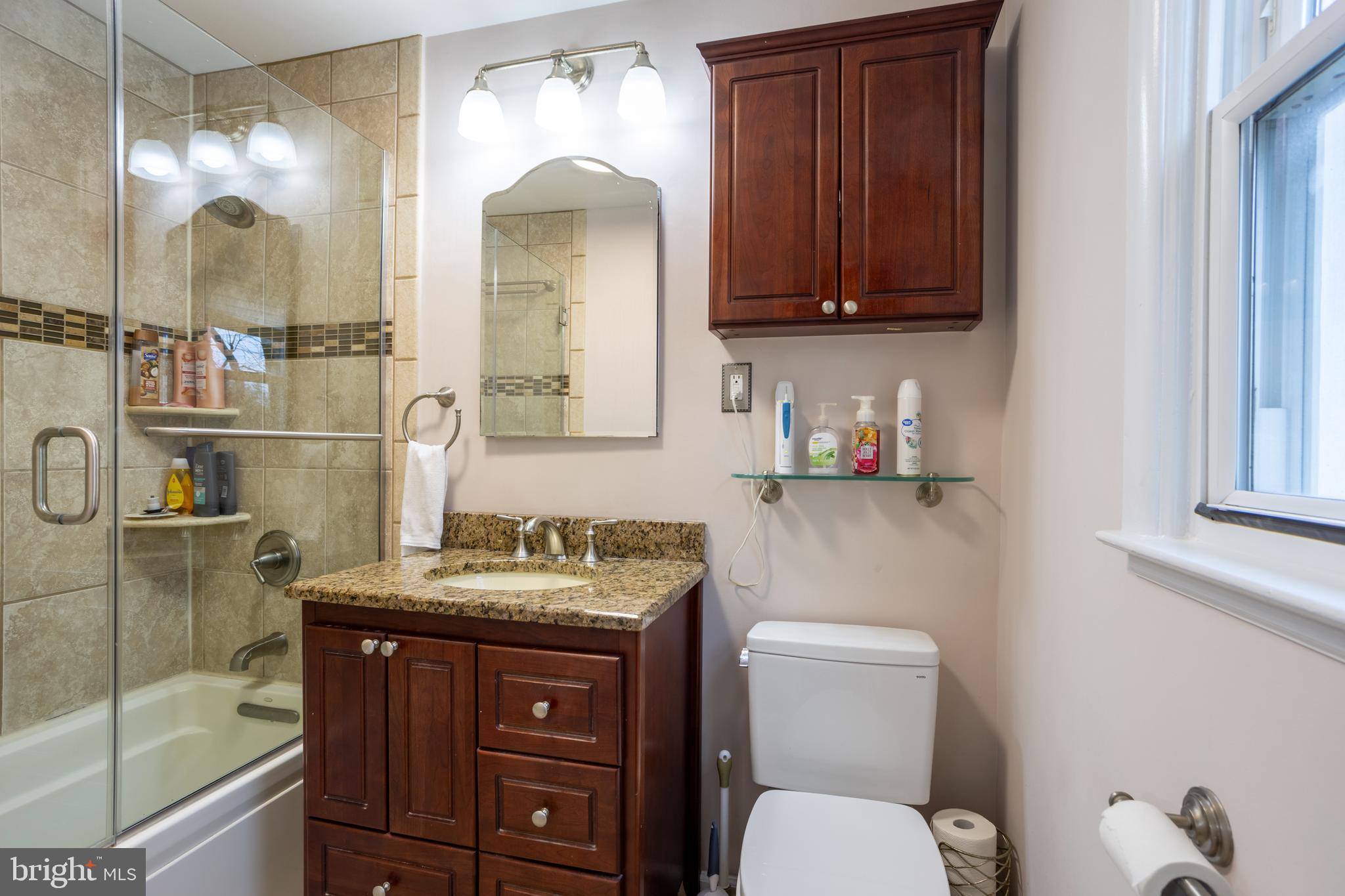 3215 Northbrook Road Baltimore, MD 21208 - Photo 23 of 50 a bathroom with a sink a toilet and shower
