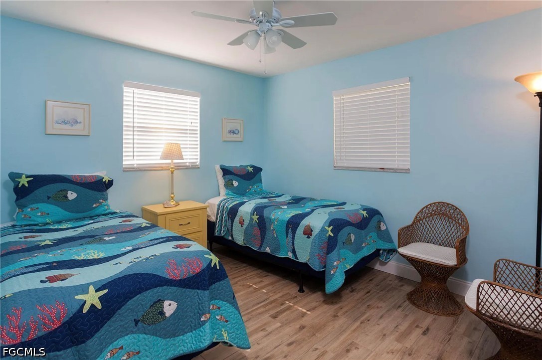 11093 Kelly Road Fort Myers, FL 33908 - Photo 7 of 12 a bedroom with two beds and a chair