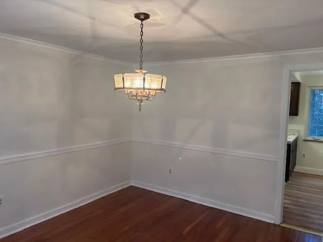 a view of a room with wooden floor and white walls