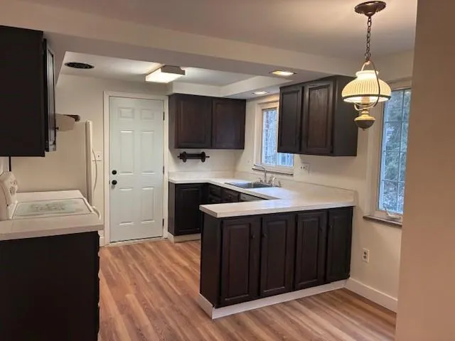 a kitchen with a sink appliances and cabinets