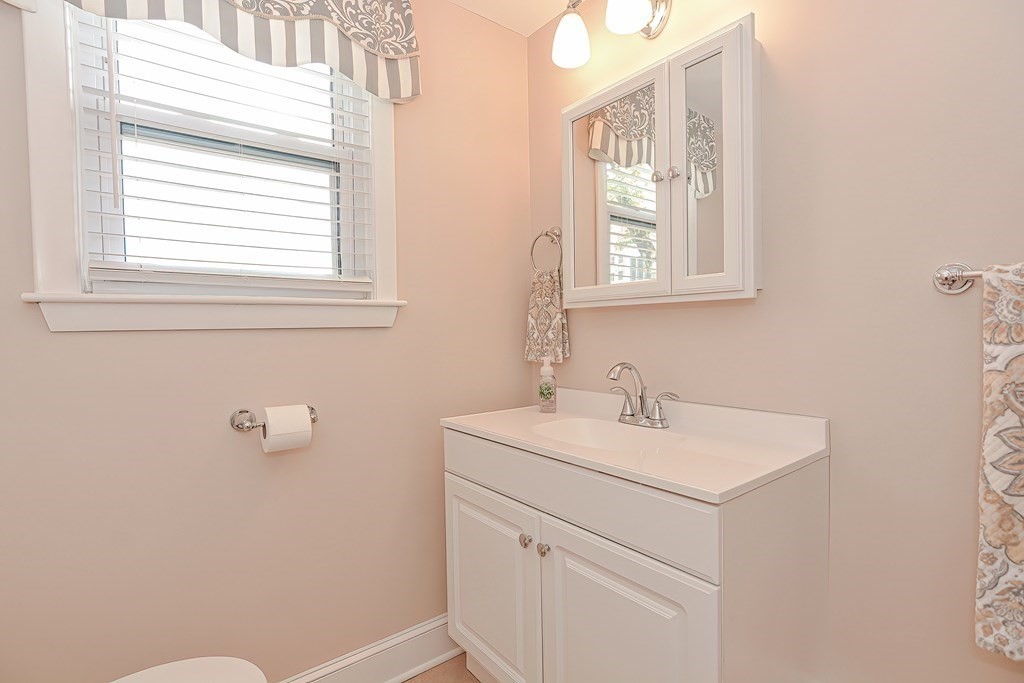 23 Edward Street Canton, MA 02021 - Photo 11 of 40 a bathroom with a sink a vanity and a window