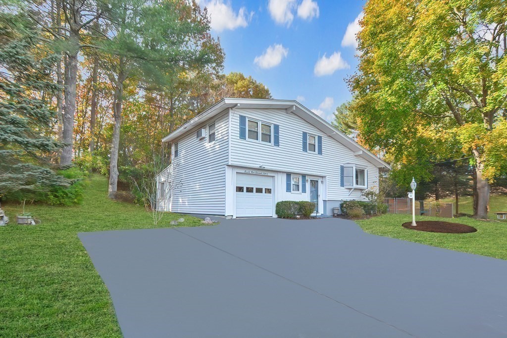 23 Edward Street Canton, MA 02021 - Photo 2 of 40 a front view of a house with a yard and trees