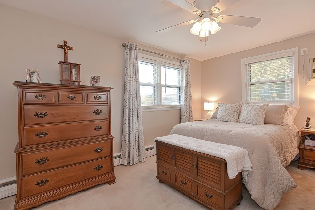 23 Edward Street Canton, MA 02021 - Photo 24 of 40 a bedroom with a bed and a chandelier