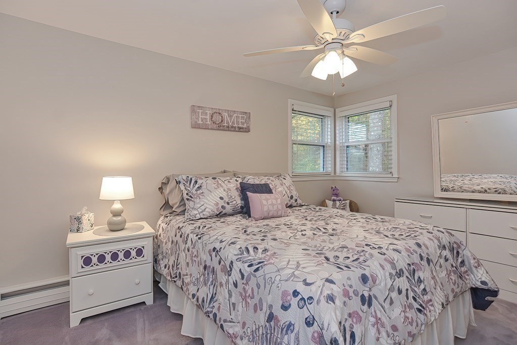 23 Edward Street Canton, MA 02021 - Photo 27 of 40 a bedroom with a large bed and a chandelier