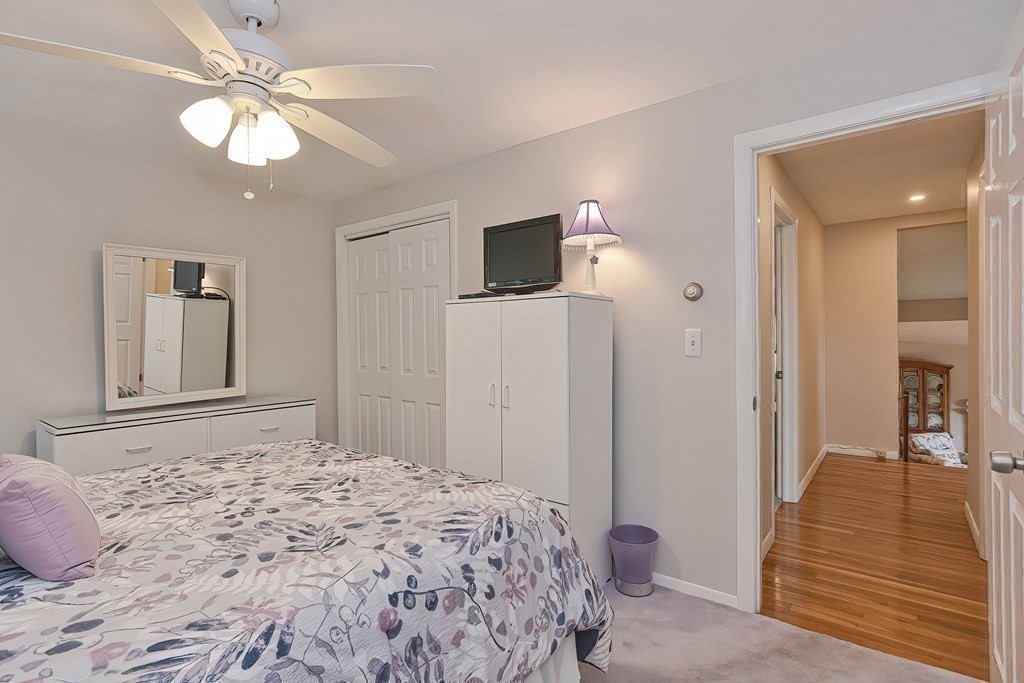 23 Edward Street Canton, MA 02021 - Photo 28 of 40 a bedroom with a bed and a chandelier