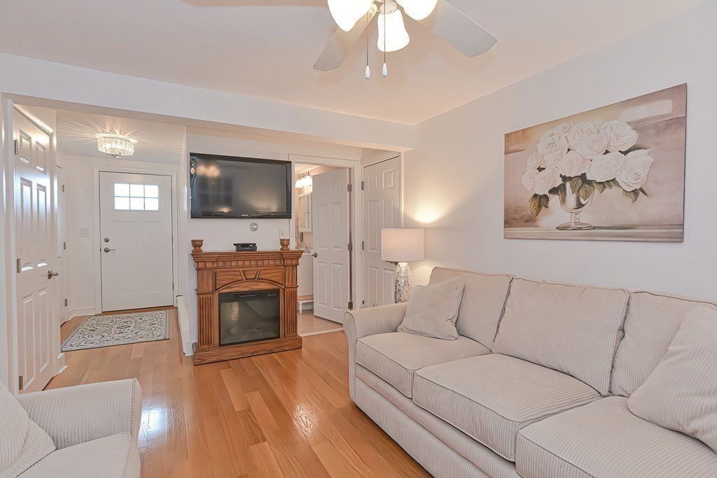 23 Edward Street Canton, MA 02021 - Photo 6 of 40 a living room with furniture a fireplace and a flat screen tv