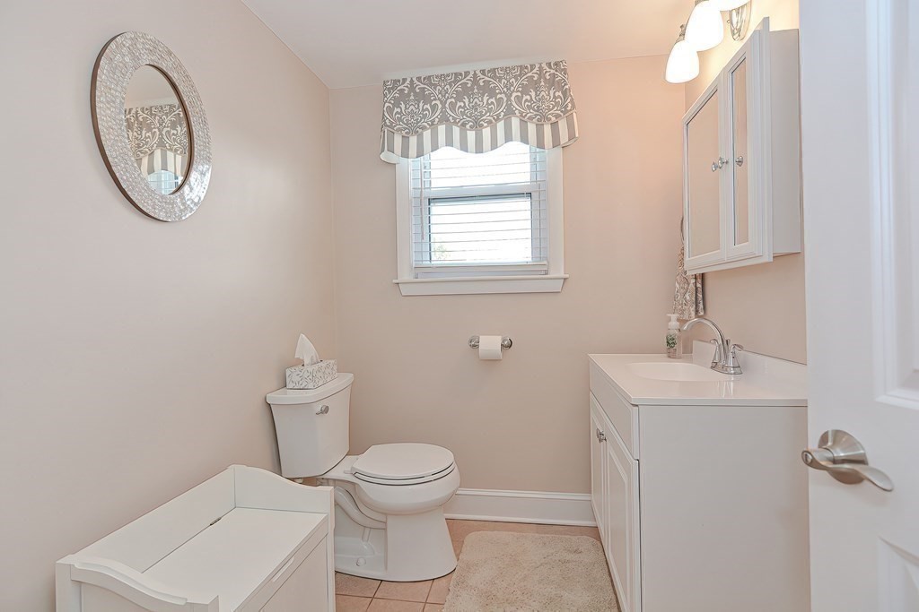 23 Edward Street Canton, MA 02021 - Photo 10 of 40 a white toilet sitting next to a bathroom sink