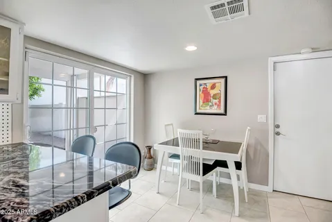 a dining room with furniture a window and a chandelier