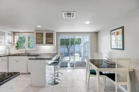 a kitchen with stainless steel appliances granite countertop a sink and cabinets