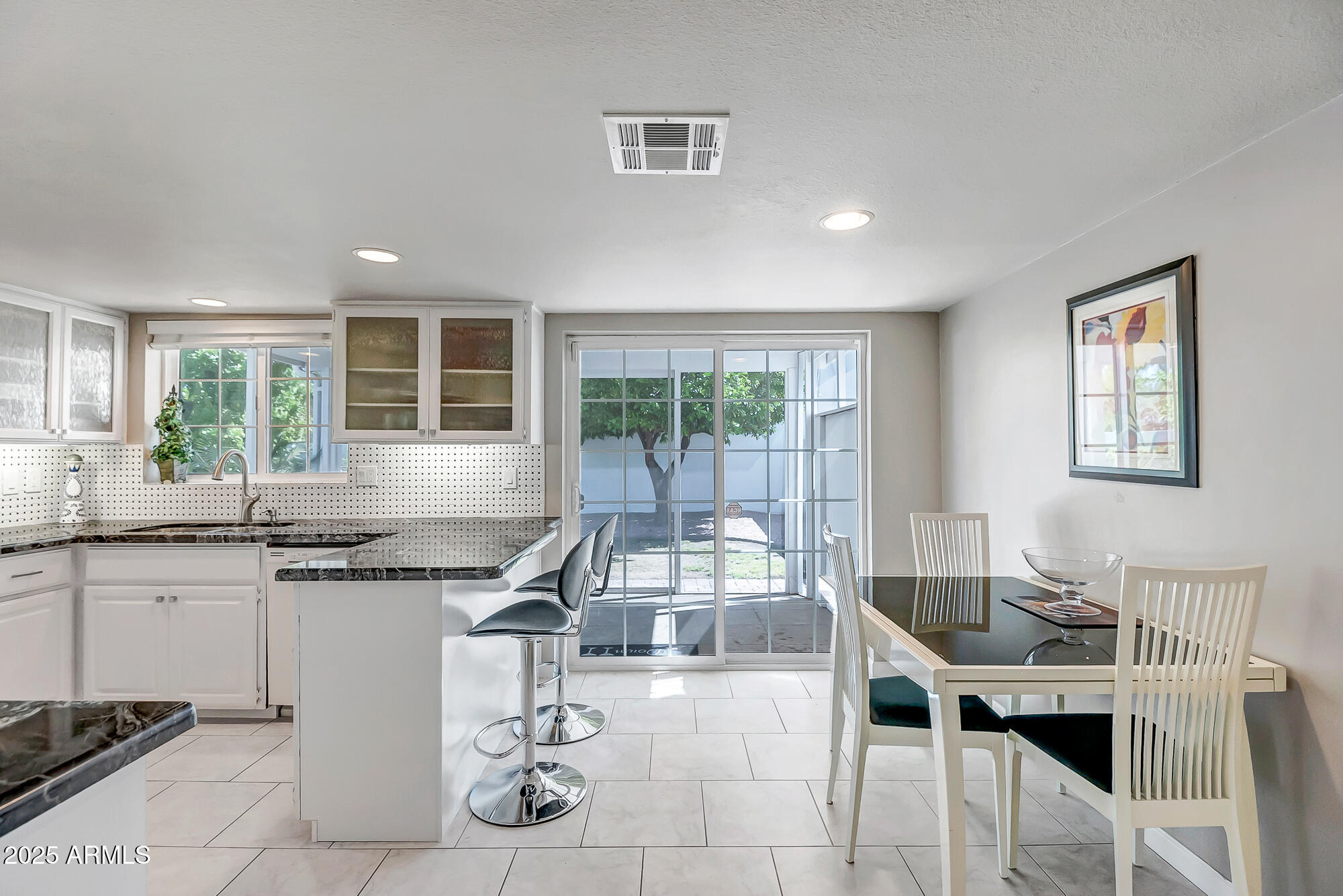 110 East Piping Rock Road Phoenix, AZ 85022 - Photo 13 of 37 a kitchen with stainless steel appliances granite countertop a sink and cabinets