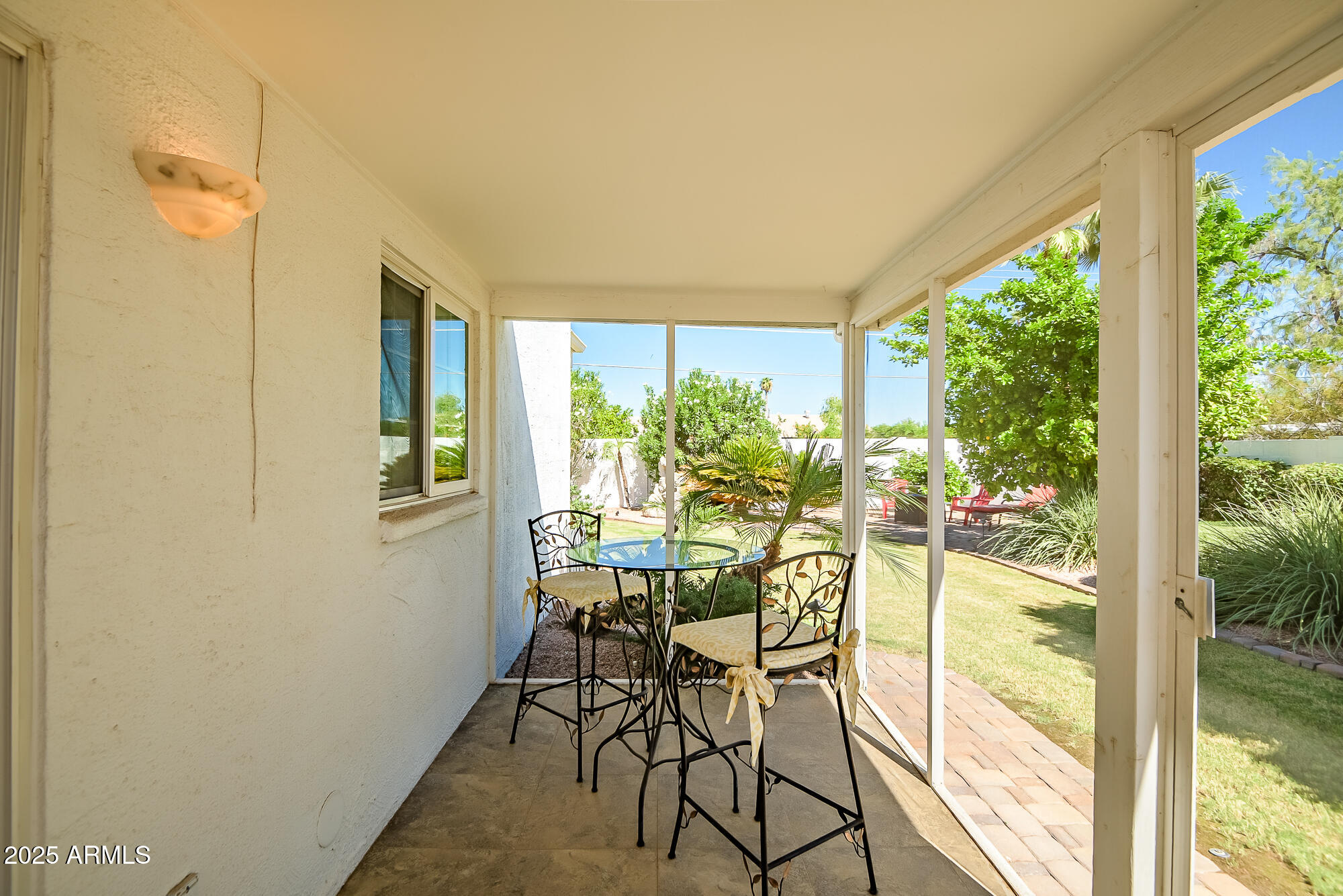 110 East Piping Rock Road Phoenix, AZ 85022 - Photo 14 of 37 a view of a porch with dining table and chairs