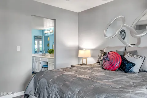 a bathroom with a granite countertop sink a toilet and a mirror