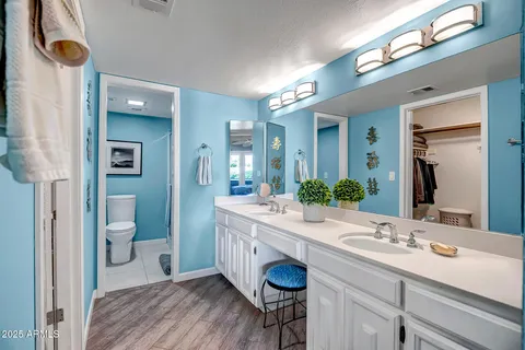 a white toilet sitting next to a bathroom sink