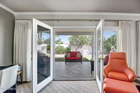 a living room with furniture and a floor to ceiling window
