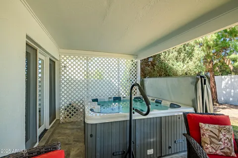 a view of a patio with table and chairs and potted plants