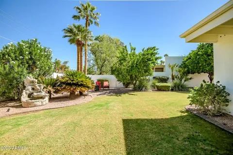 a view of a house with table and chairs in patio