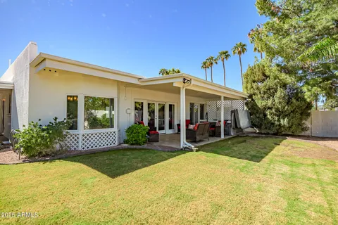 a view of a swimming pool with a table and chairs