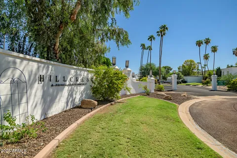 a view of a house with a yard and palm trees