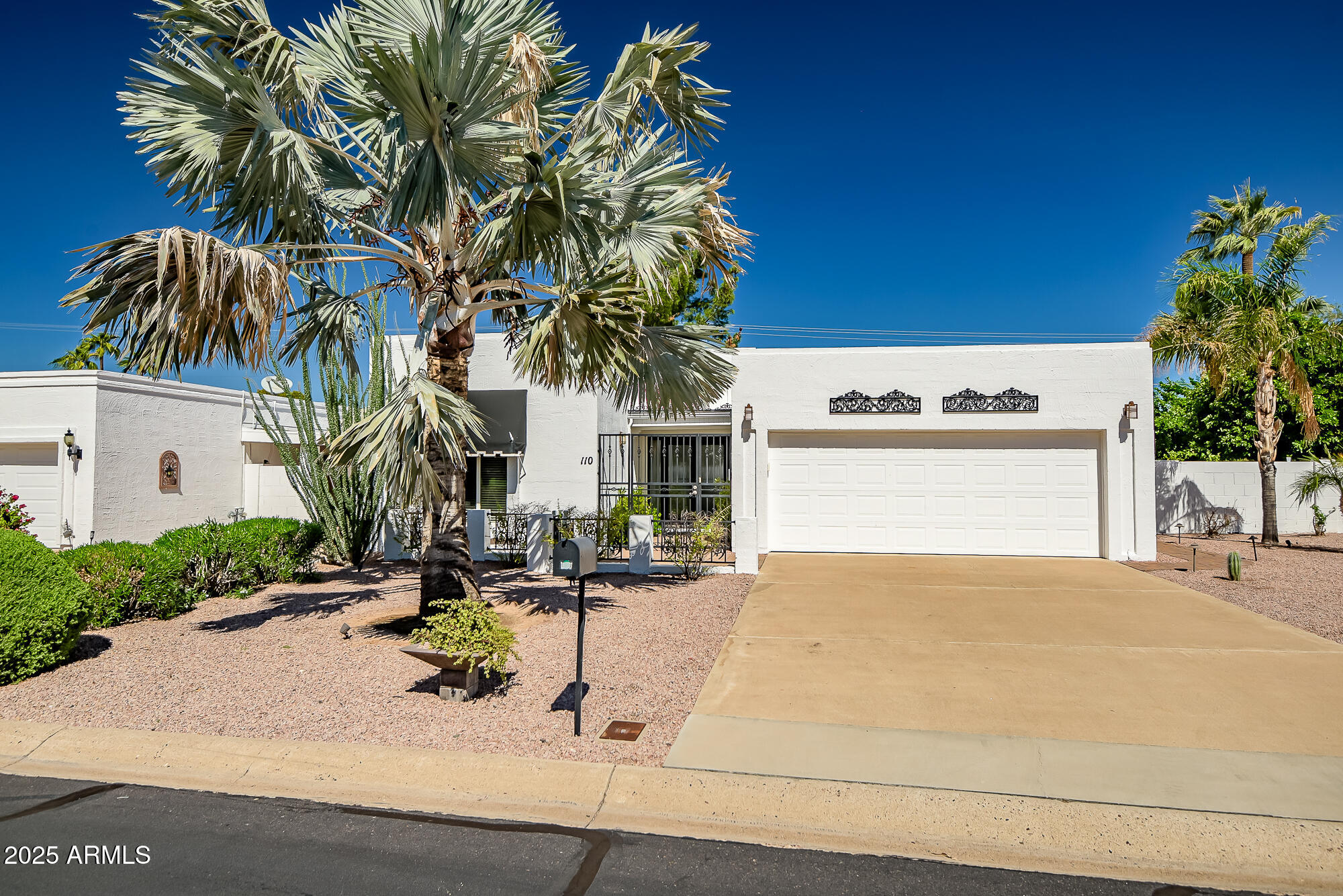 110 East Piping Rock Road Phoenix, AZ 85022 - Photo 37 of 37 a view of a house with a yard and palm trees
