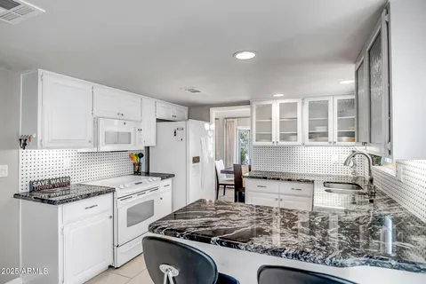 a kitchen with a stove a sink and a refrigerator