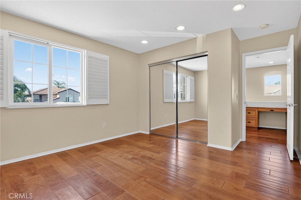 20543 Pesaro Porter Ranch Porter Ranch, CA 91326 - Photo 46 of 67 a view of an empty room with wooden floor and a window