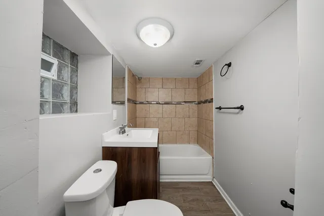 a bathroom with a sink mirror toilet and shower