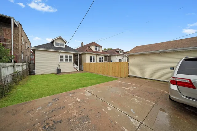 a front view of a house with a garden and yard