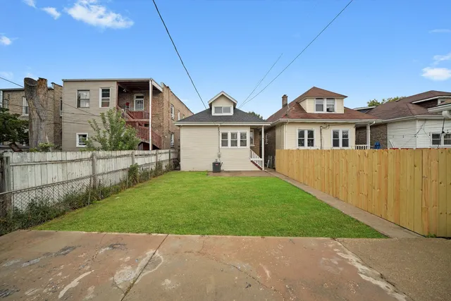 a front view of a house with a garden and yard
