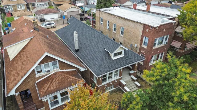 an aerial view of a house with a yard