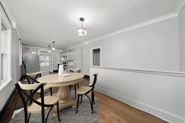 a view of a dining room with furniture and wooden floor
