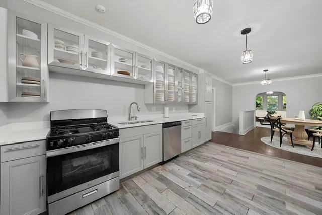 a kitchen with stainless steel appliances granite countertop a stove and a sink