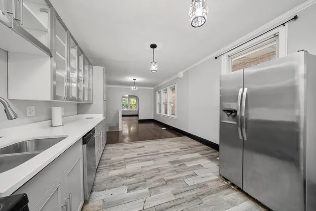 a kitchen with stainless steel appliances granite countertop a sink and refrigerator