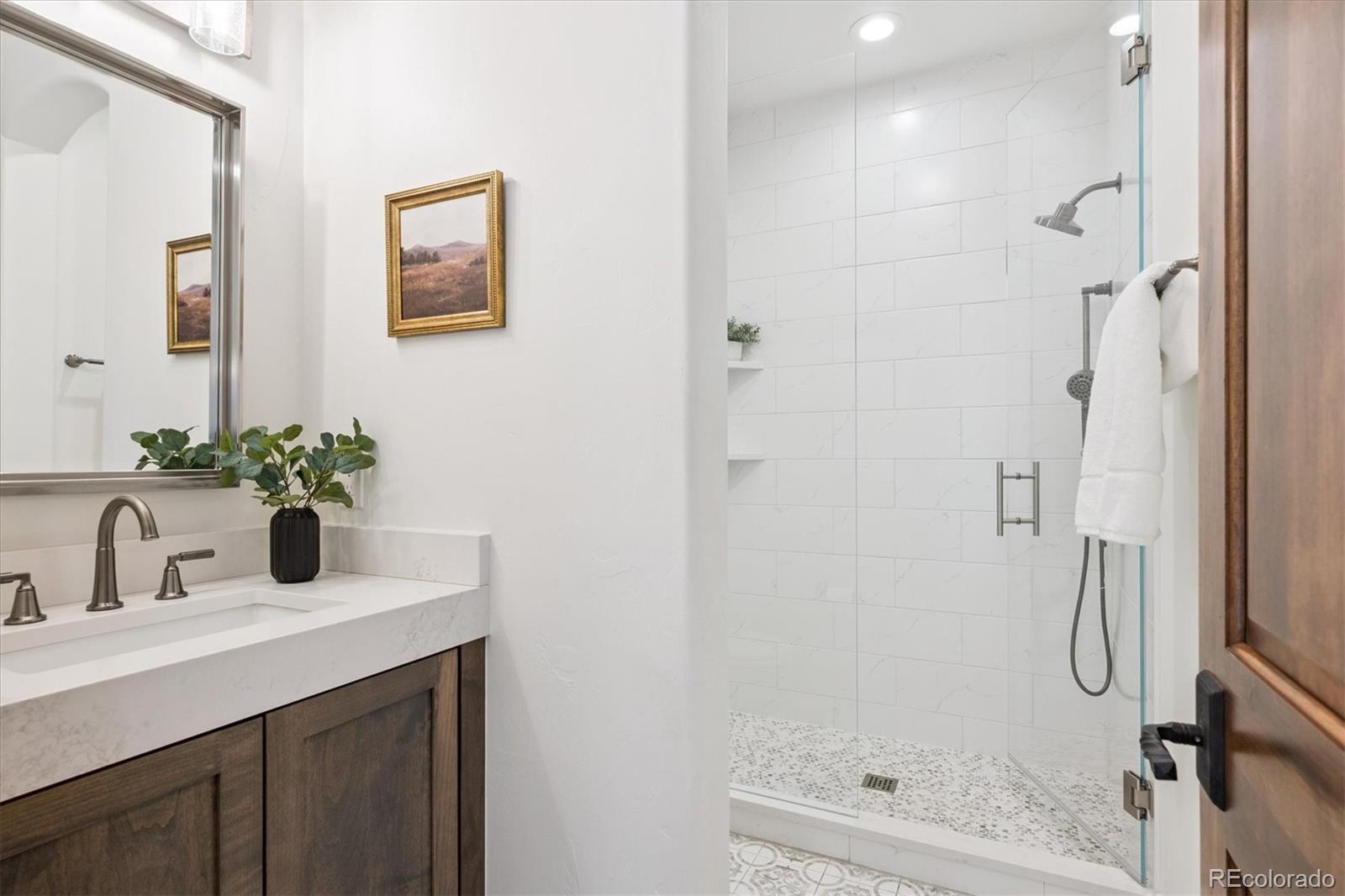 2415 South Madison Street Denver, CO 80210 - Photo 17 of 37 a bathroom with a sink a toilet and shower