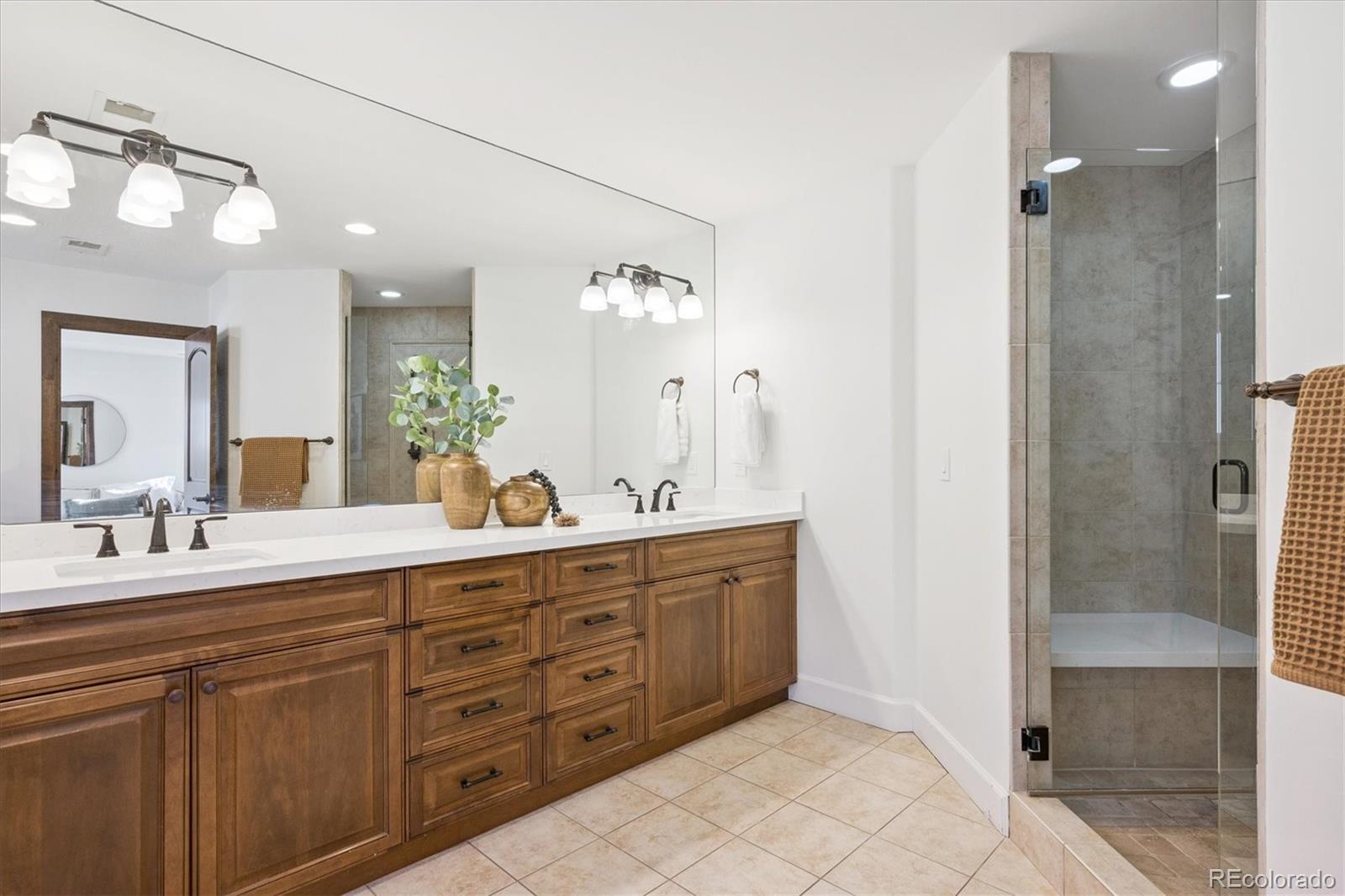 2415 South Madison Street Denver, CO 80210 - Photo 24 of 37 a spacious bathroom with a double vanity sink shower and a mirror